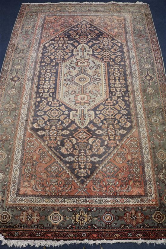 An Iranian red ground rug, 7ft 3in. x 4ft 10in.